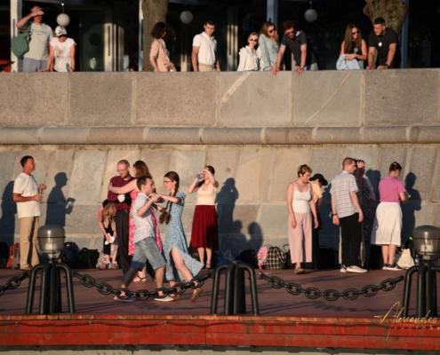 Persone e coppie che ballano all'aperto sul lungofiume del parco Gorkij a Mosca